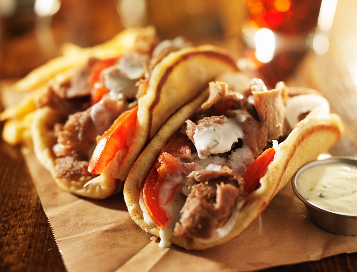 A loaded CISSNE'S beef and lamb gyro with cool house tzatziki and a side of hand-cut fries